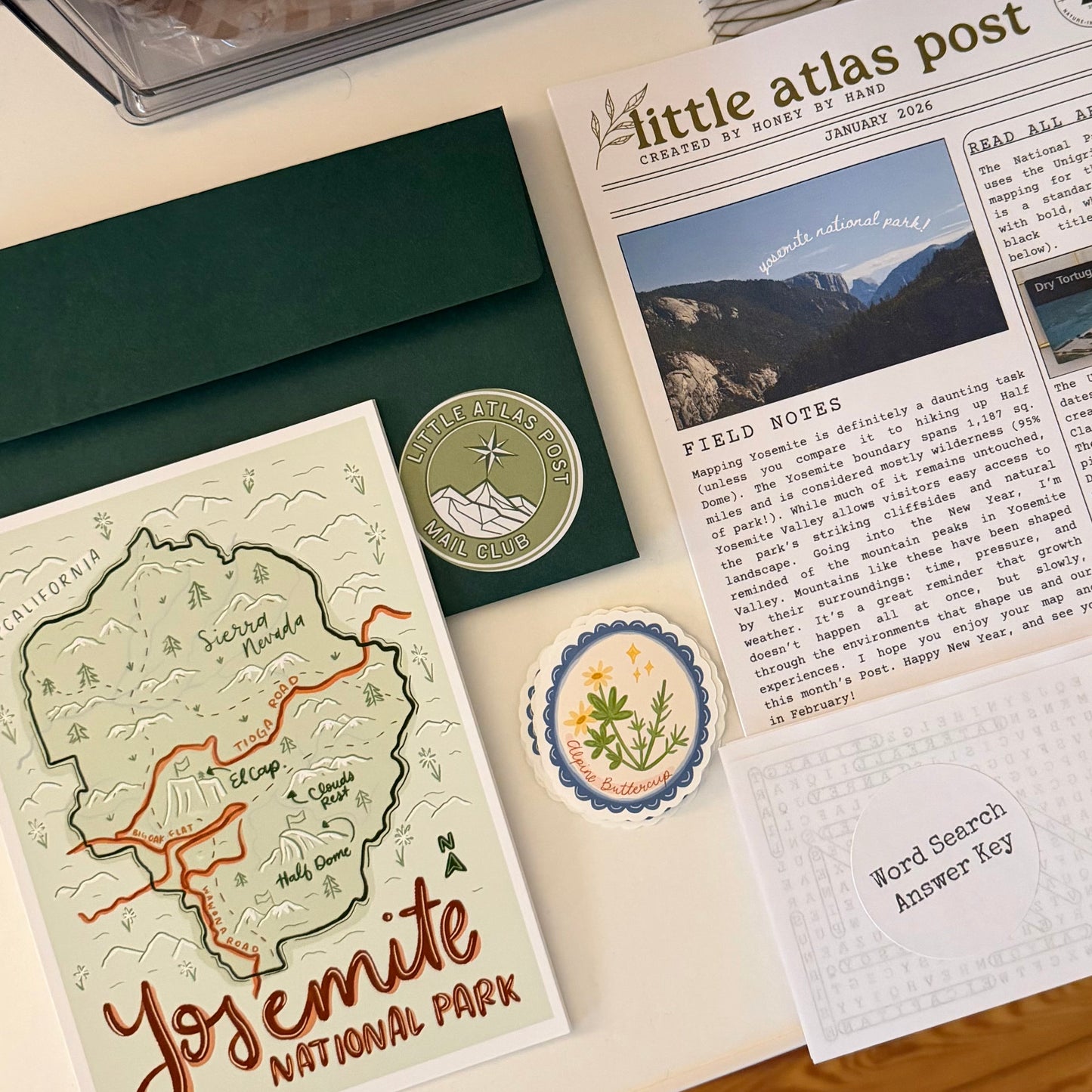 Stationery set with a map, postcard, and letter on a wooden surface